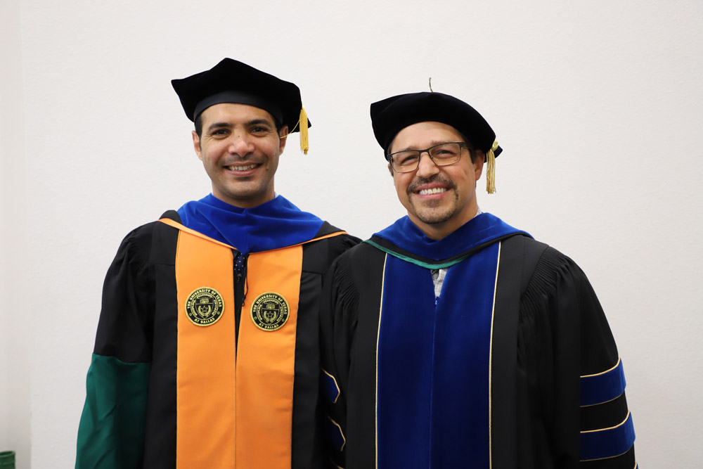 Mohammad, in regalia, with one other at doctoral hooding ceremony.
